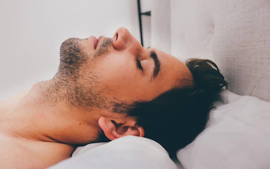 Relaxed man with head lying on pillow