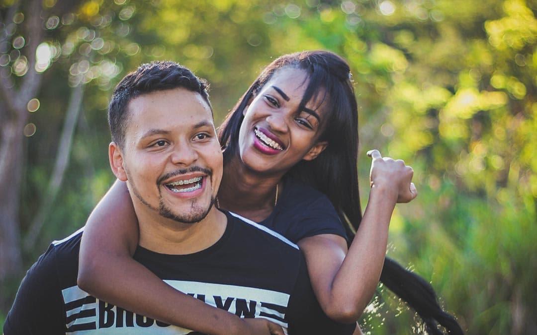 Woman on top of man in black shirt