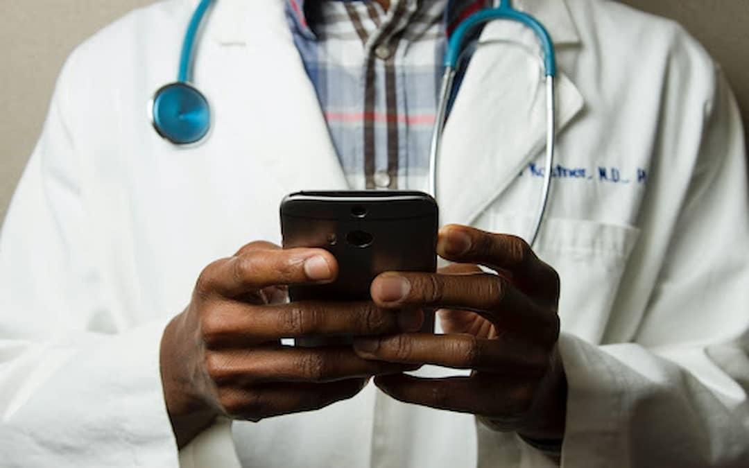 Doctor Holding Cell Phone